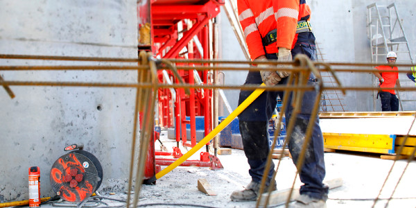 ¿Cómo prevenir el riesgo de sufrir de la espalda asociado al desplazamiento de cargas pesadas en una obra de construcción?
